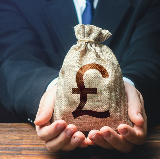 Image showing a man in a suit holding a small money bag 